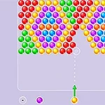 다양한 색상의 구슬들이 삼각형 패턴으로 배열된 화면 중앙에 노란색 화살표가 있는 이미지