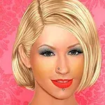 금발의 단발머리를 한 여성이 화려한 분홍색 배경 앞에 있고, 눈과 입술에 짙은 화장을 하고 있습니다