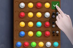 나무 보드 위에 다양한 색상의 구슬이 놓여 있고, 손가락이 체크 표시 버튼을 누르고 있는 모습