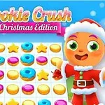 알록달록한 쿠키와 도넛이 그려진 게임 보드 앞에 산타 복장을 한 캐릭터와 장식된 크리스마스트리가 있는 이미지