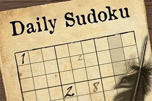 일부 숫자가 채워진 빈 스도쿠 퍼즐과 깃털 펜