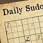 일부 숫자가 채워진 빈 스도쿠 퍼즐과 깃털 펜