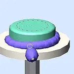 회전하는 원형 받침대 위에 파란색과 민트색 원형 물체가 놓여 있습니다