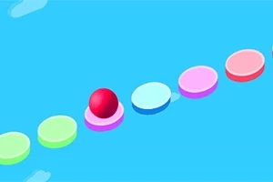 알록달록한 원형 플랫폼 위에 빨간 공이 놓여 있는 장면