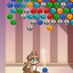 고양이가 다양한 색상의 공을 향해 파란색 공을 쏘는 포즈를 취하고 있는 이미지