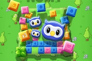 푸른 올빼미 얼굴들과 여러 색상의 블록들이 녹색 배경 위에 놓여 있는 모습