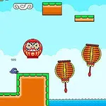 밝은 하늘 배경에 다루마 인형과 드럼 모양의 장애물이 있는 플랫폼 게임 화면