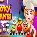 주방에서 유령 컵케이크를 들고 있는 요리사 여자와 다양한 색상의 할로윈 컵케이크