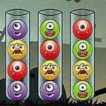 4개의 투명한 관에 각기 다른 색깔의 외눈박이 몬스터 얼굴이 들어가 있는 이미지