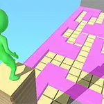 녹색 캐릭터가 탑 위에 서서 분홍색과 노란색 타일 길을 바라보는 모습