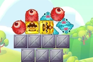 알록달록한 괴물 모양의 블록들이 회색 금속 상자 위에 쌓여 있는 모습