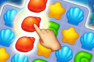 바다 조개와 별 모양의 퍼즐 조각들이 놓인 게임 화면에서 손가락으로 빨간 조개 조각을 가리키고 있는 모습