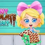 귀여운 소녀가 초콜릿 상자를 들고 있는 모습과 Yummy Chocolate Factory라는 글자가 있는 이미지